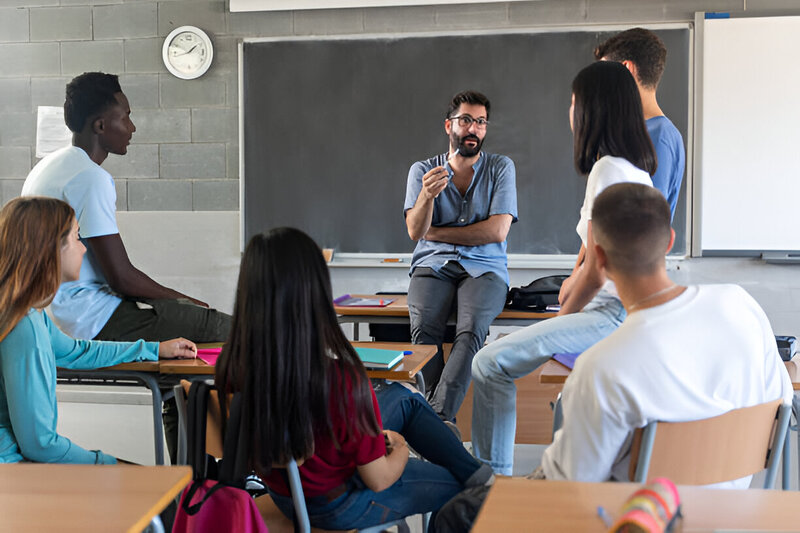 A mentor teaching his diverse culturally fit team in a work setting